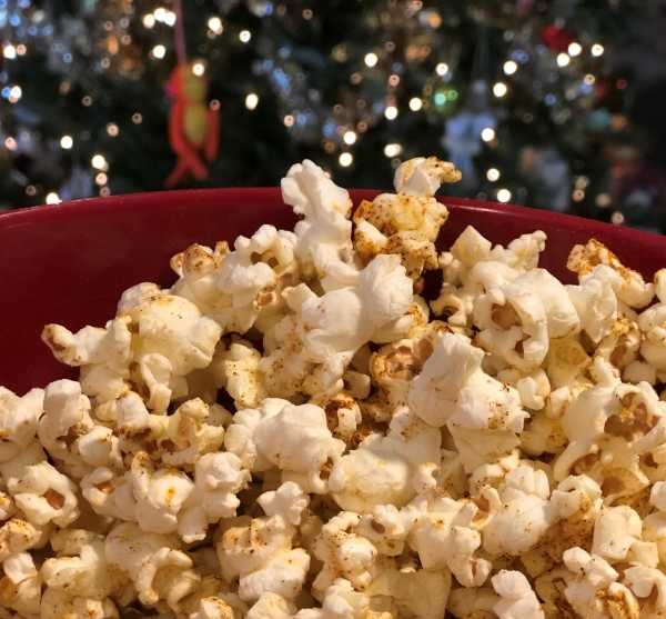 Savory Cajun-Spiced Popcorn in front of a Christmas Tree