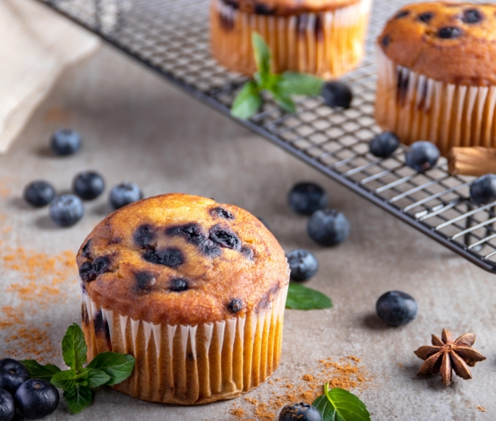 Greek Yogurt Blueberry Muffins Blueberry muffin over a stone table