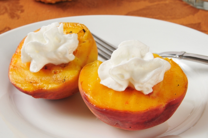 Grilled Peaches with Pecan Brown Butter Sauce Lightly grilled peach halves with whipped cream
