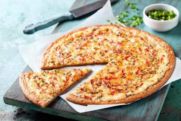 Gluten free white pizza with bacon and green onions,