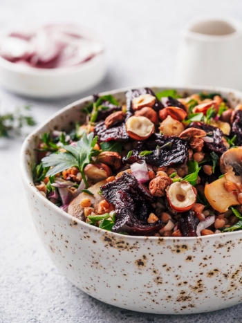 Vegetarian/vegan salad with beetroot, buckwheat, mushrooms, onion, fresh herbs, hazelnut. 