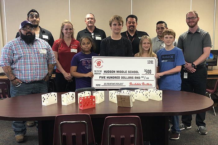 A group of Brookshire Brothers employees presenting a $500 donation to the students in Mr. Matheny's 3D Design class.