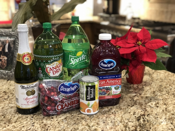 All the ingredients needed for the Christmas party punch recipe sitting on a kitchen counter. 